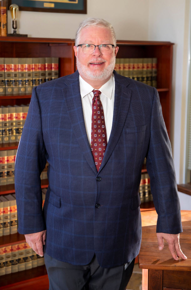Photo of attorney Gary Jones in front of bookshelves